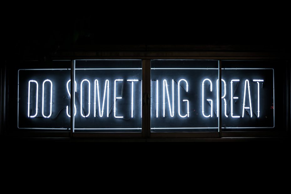 Image of a black background with neon text that says 'Do Something Great' in bold letters.